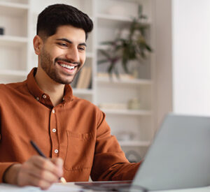 Man smiling using laptop