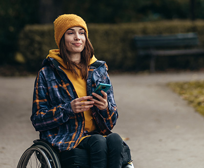 Woman in wheelchair using mobile