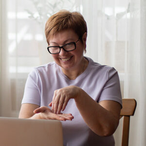 woman using sign language at her laptop