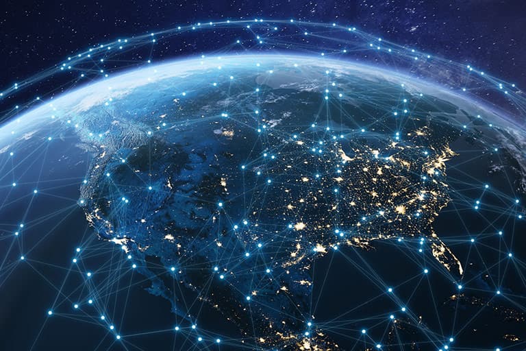 Globe at night with illuminated cities and connected data nodes, representing large-scale digital interactions and insights across public sector networks.