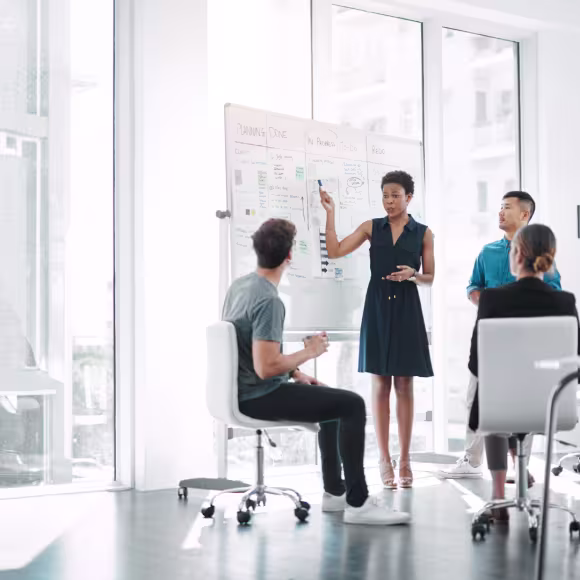 Business people in a office writing on a whitepaper