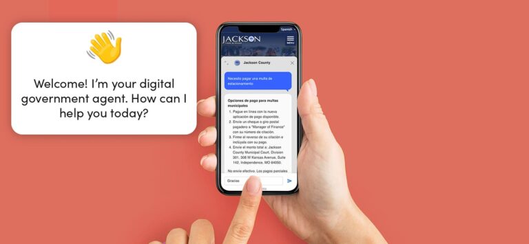 Hands holding a phone and interacting with Government Experience Agent on Jackson County government's website.