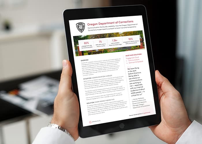 Person holding a tablet displaying a success story about the Oregon Department of Corrections’ modernized communication strategy, featuring statistics and an overview of trust-building initiatives.