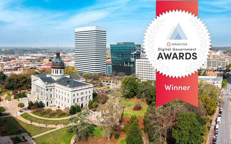 Aerial view of the South Carolina State House and surrounding city buildings with a red “Granicus Digital Government Awards – Winner” badge overlaid on the right side of the image.