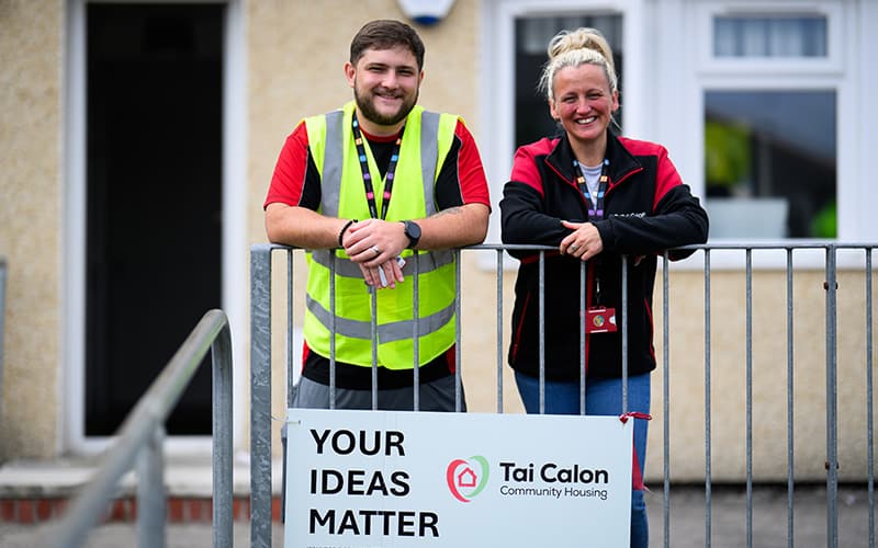 Two members of the Tai Calon team stand above a brand 