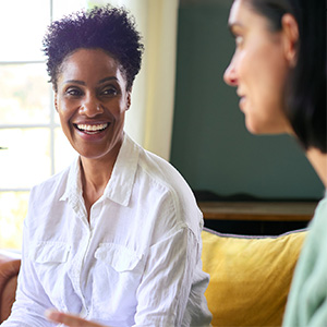 Two women talking on a couch