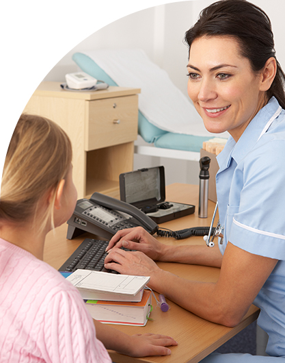 Healthcare worker talking to young patient in office