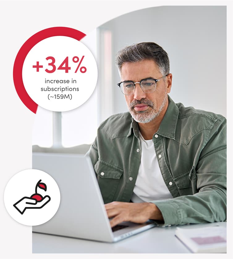 A government engagement leader wearing glasses using a laptop, focuses on the screen. A circular graphic shows 