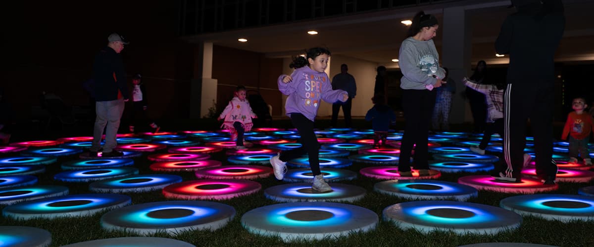 Kids in the community playing with an interactive light up display at Aurora, Illinois, LUMEN