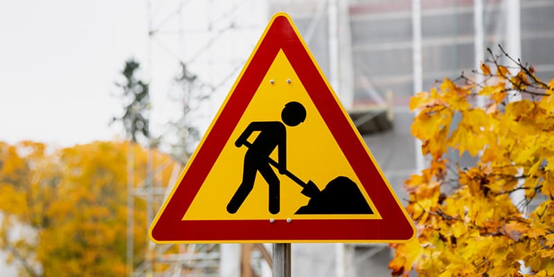 Construction warning sign near a public building project, symbolizing local government infrastructure work that can spark public records requests