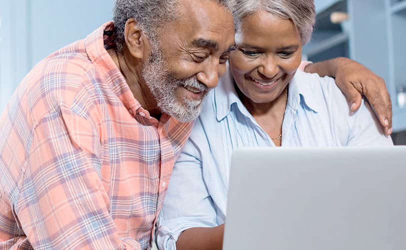 An older African-American couple accessing helpful government services on their laptop