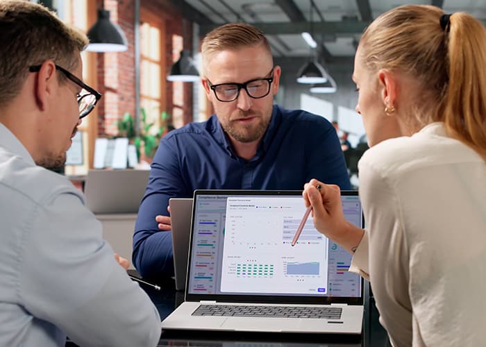 Diverse team reviewing risk data dashboard