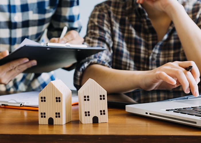 Real estate agents signing home sale