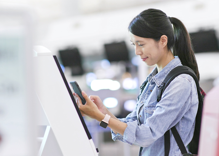 Woman using a self-service machine