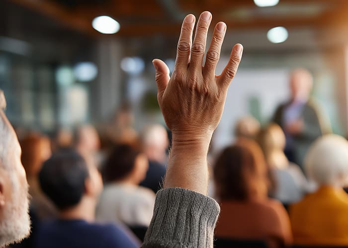 Faceless diverse community members gathering at neighborhood meeting