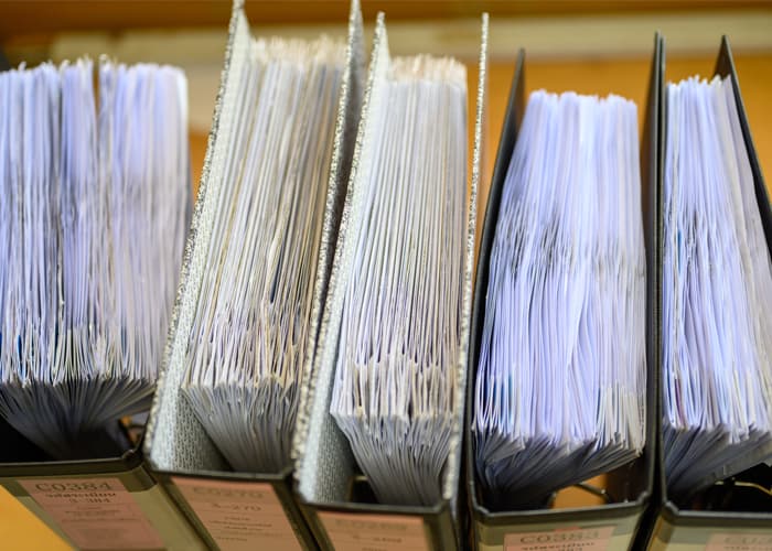 Documents waiting to be approved, placed at the office desk
