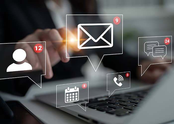 Man hands interacting with Laptop and Notifications for Emails, Messages, and Appointments icons overlay