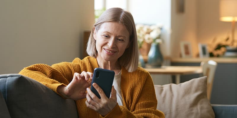 Woman in her 60s using an online government portal for digital services instead of calling or walking in. 