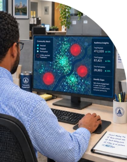 Person viewing a community reach dashboard with audience engagement and participation data on a desktop monitor.