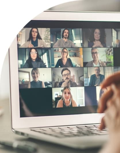A laptop screen with tiles of different people shown attending a webinar.