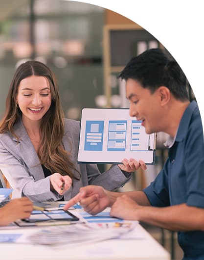 Team gathered in a meeting room analysing data.