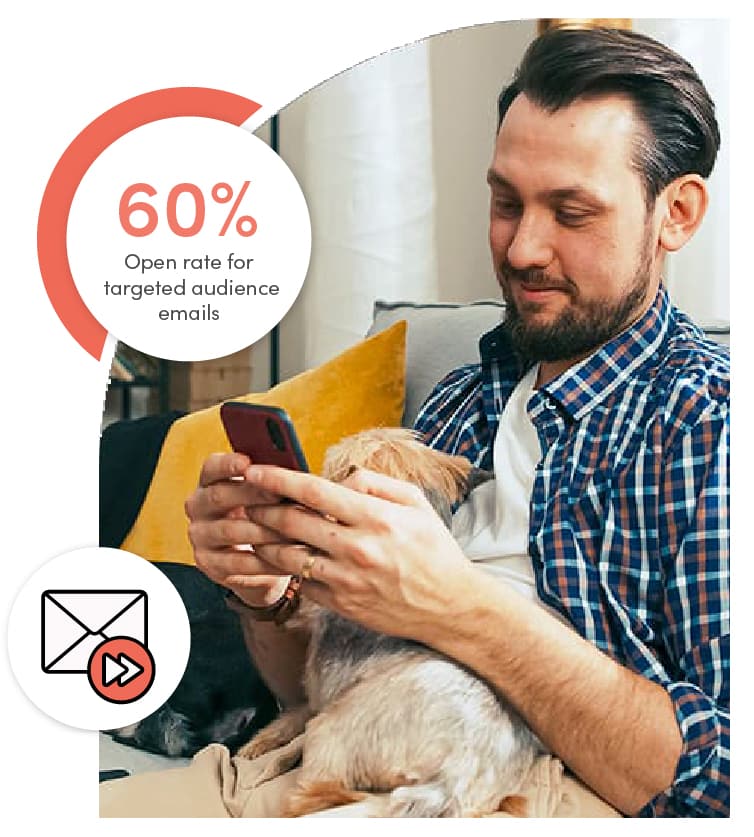 Person sitting on a couch using a smartphone while holding a small dog, illustrating convenient, on‑the‑go engagement.
