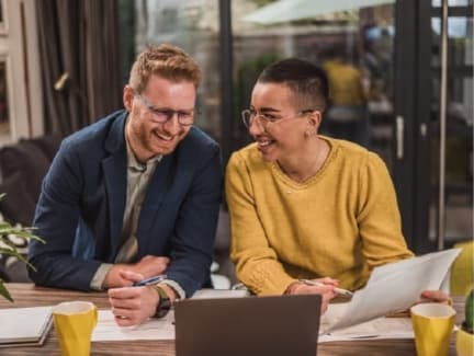 A male and female government employee collaborating on a Zoom call while receiving expert guidance and insights from Granicus' Customer Experience Services team.