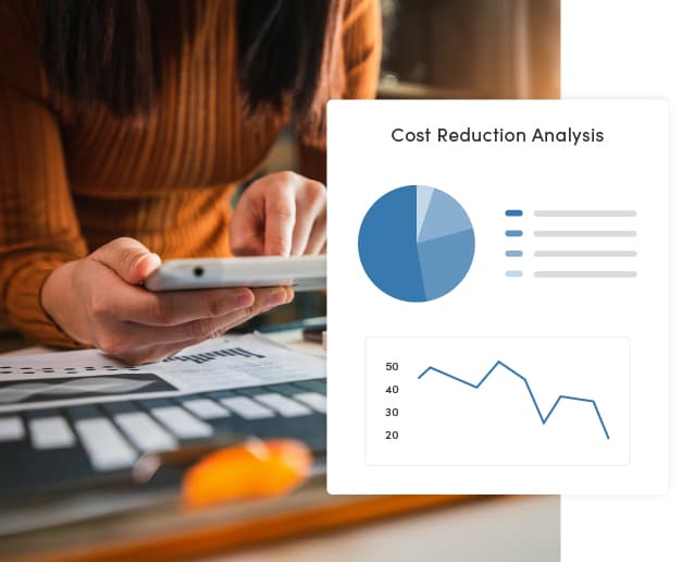 A federal government employee reviewing cost reduction analysis reports on her tablet. The image displays a tech overlay with a pie chart and a line graph illustrating a decline in costs over time.