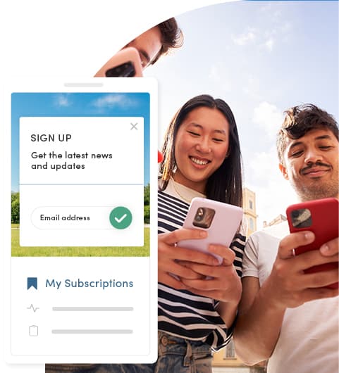Three people smile while using smartphones outdoors, suggesting a positive and engaging moment. A mobile-responsive government website signup form overlay asks for email subscriptions.