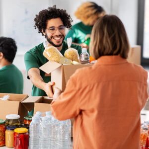 Young man volunteering with a government program to provide food to those in need.