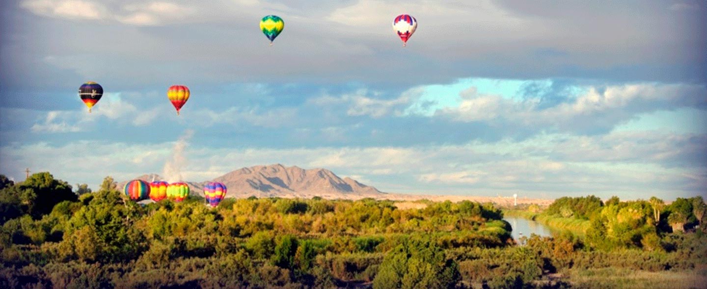 Hot air balloons in the sky with mountain in the background