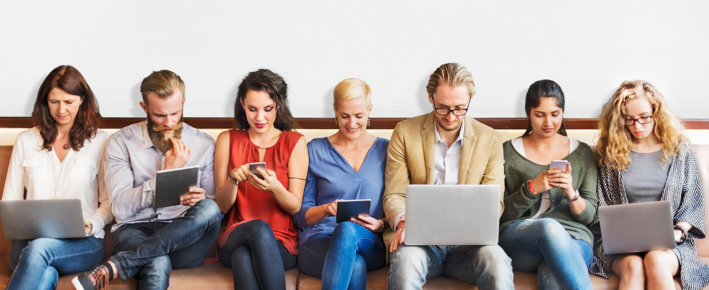 group of people sitting on a couch using devices - community engagement