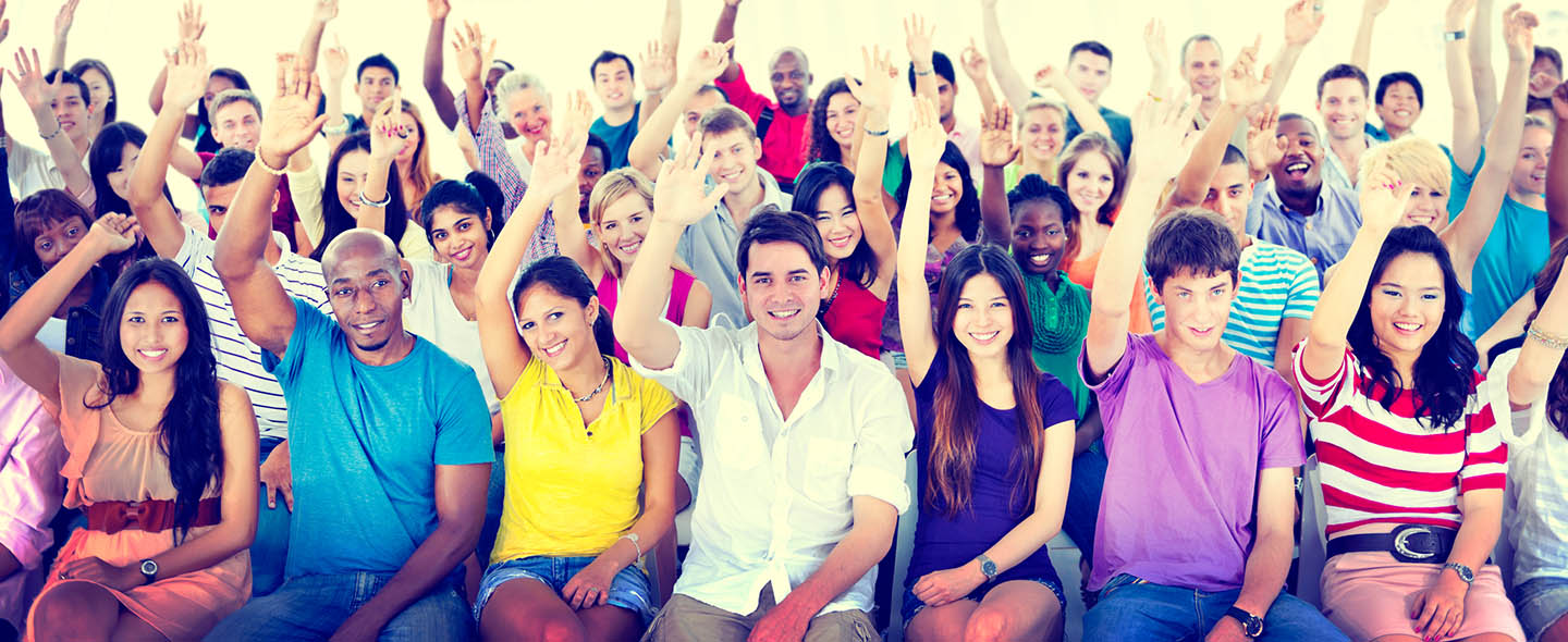 large group of people raising their hand, audience raising their hands