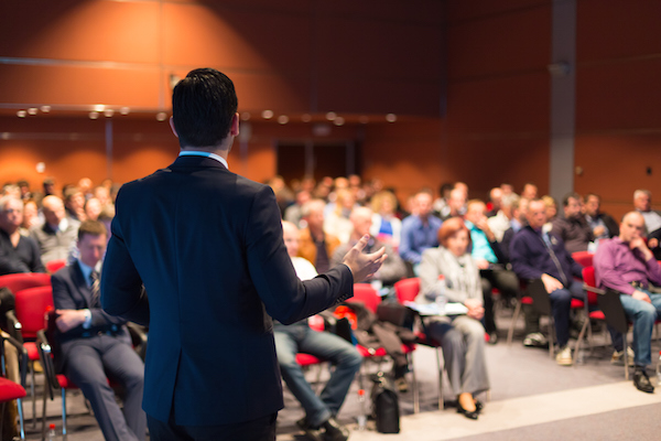 A Complete Guide to Making Your Next Public Sector Event a Success image A man speaking at a business conference
