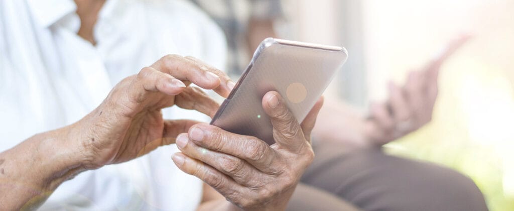 Elderly person using mobile phone