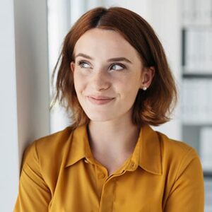 Destination marketer smiling while thinking in her office