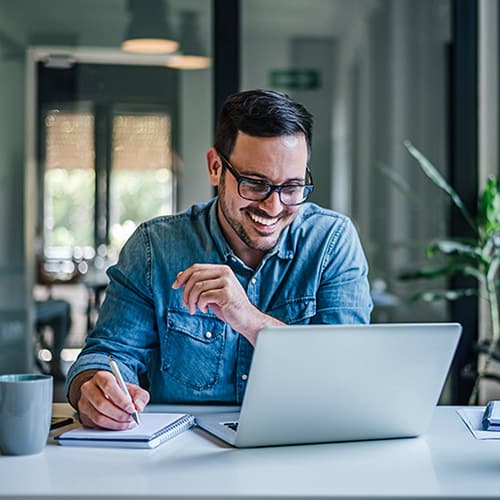 Man smiling at computer