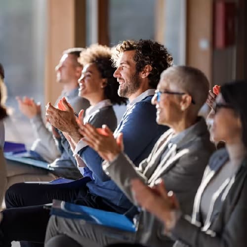 Group of professionals clapping at an event