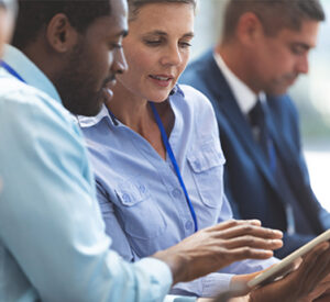 Two government staff reviewing communications on tablet