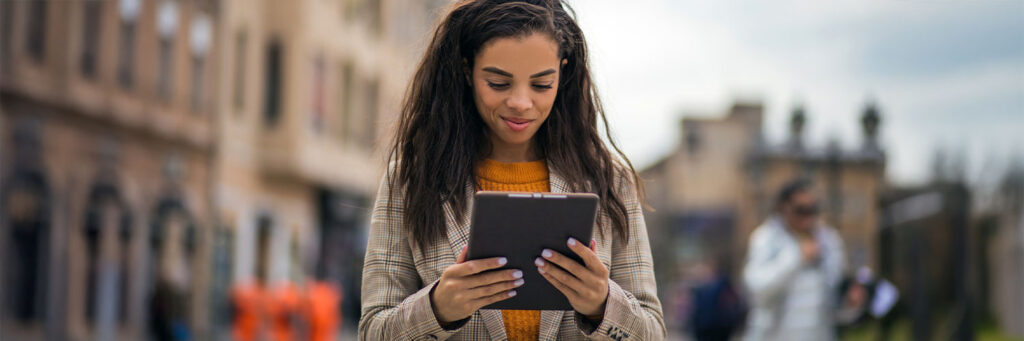 Young woman using her tablet, with a focused expression, and enjoying the moment.