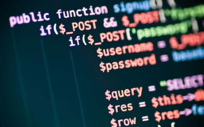 Colorful PHP code displaying POST data, username, password and database query variables on a dark screen.