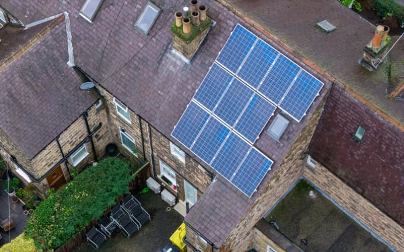 Aerial view of a housing association property with rooftop solar panels showcasing energy‑efficient improvements for tenants.