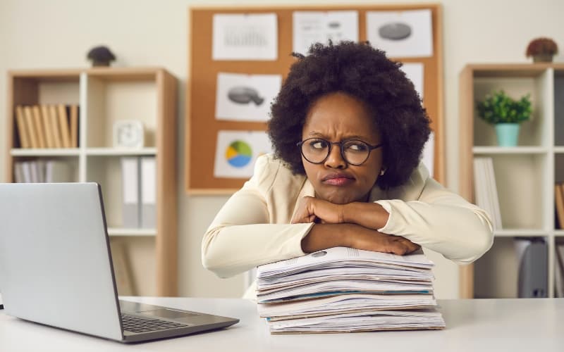 Healthcare administrator reviewing enrollment redetermination documents to reduce compliance burden.