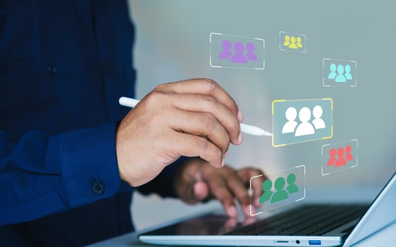 Hand selecting digital audience groups on a laptop, illustrating the importance of precise segmentation during crisis communication.