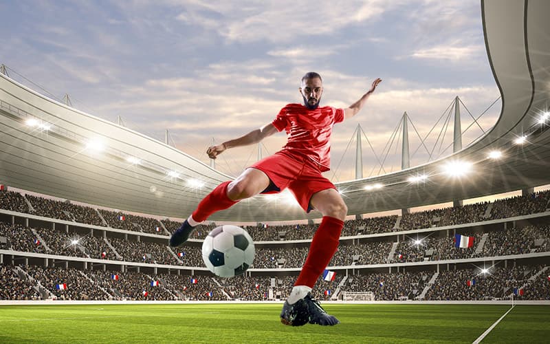 Professional kicking a soccer ball in a stadium