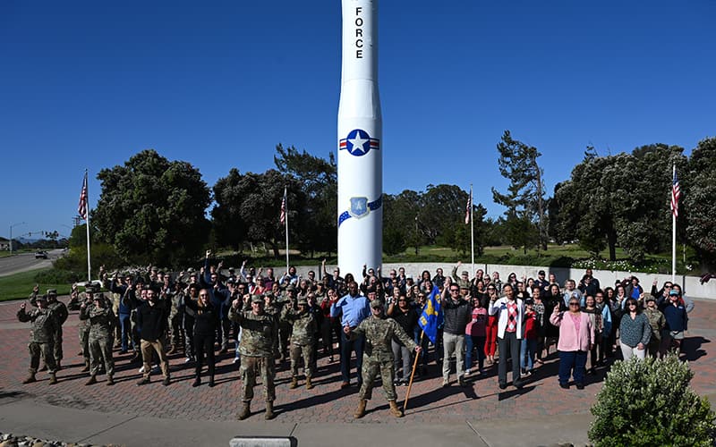 The 30th Force Support Squadron pose for a group photo in front of Missile V, a Minuteman III missile static display at Vandenberg Space Force Base, Calif., May 7, 2024. PHOTO BY: Airman 1st Class Olga Houtsma – This photograph is considered public domain.