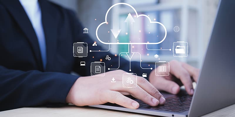 Businessman using a laptop with virtual icons representing document management, digital file storage, online database technology, and records access.